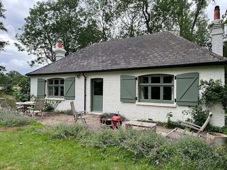 Painted bungalow exterior with clean white walls and green accents
