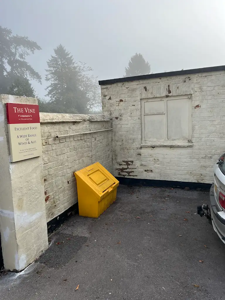 Painted outdoor utility area with clean walls and bin storage space