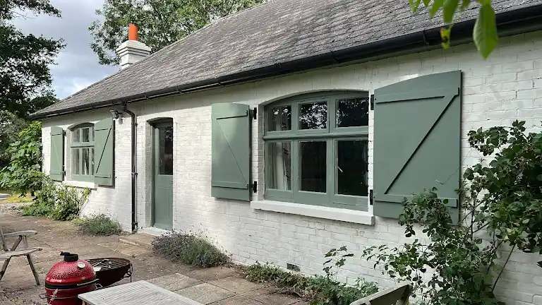 Empty interior room with freshly painted white walls and green carpet
