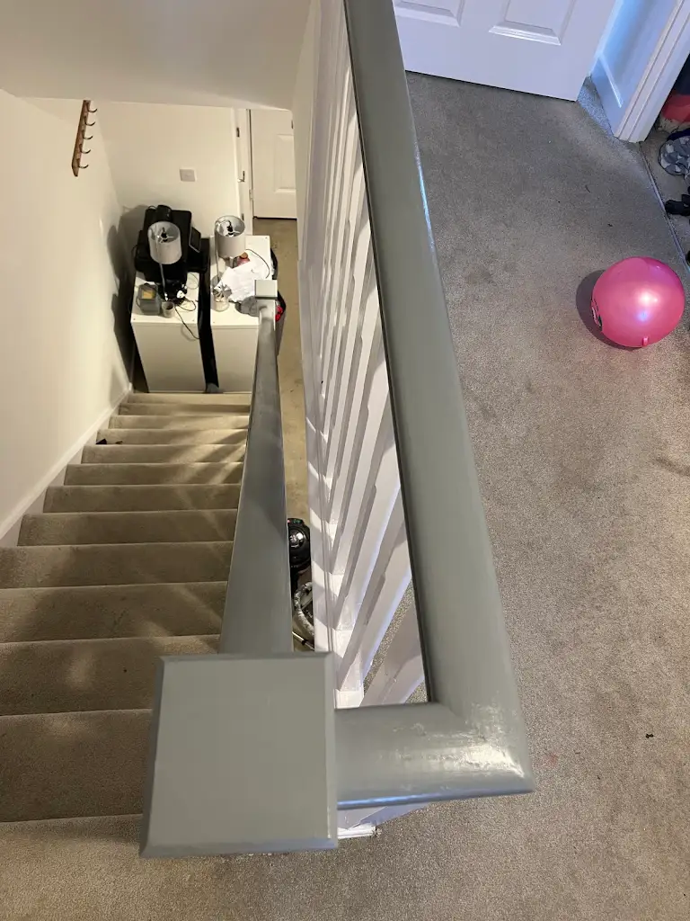 Interior stairway painting with smooth wall finish and neat edges