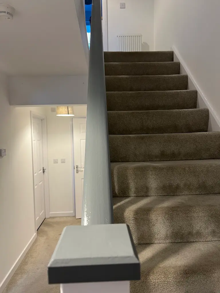 Hallway staircase painting with clean walls and modern interior look