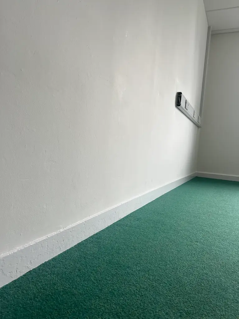 Hallway painting work in progress with protective floor covering