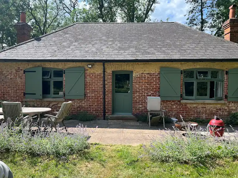 House exterior painting with windows and green shutters, refreshed look